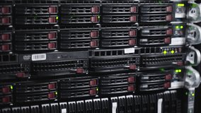Close-up of densely packed server racks in a data center, with glowing green LEDs and red drive handles. A detailed view of enterprise-grade storage hardware powering cloud services, data backup - Powered by Shutterstock - Get 15% off with code: PIKWIZARD15