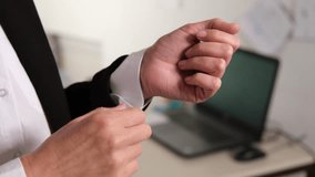 An office worker or a man in a white shirt and black jacket, a boss or businessman is getting ready to go somewhere, adjusting the sleeves of his shirt or clothes, to an important meeting or to work. - Powered by Shutterstock - Get 15% off with code: PIKWIZARD15