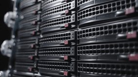 Rows of sleek server racks in a modern data center, with glowing blue LEDs and red drive handles. A sharp, angled close-up showcasing the precision and scale of enterprise-grade IT infrastructure  - Powered by Shutterstock - Get 15% off with code: PIKWIZARD15