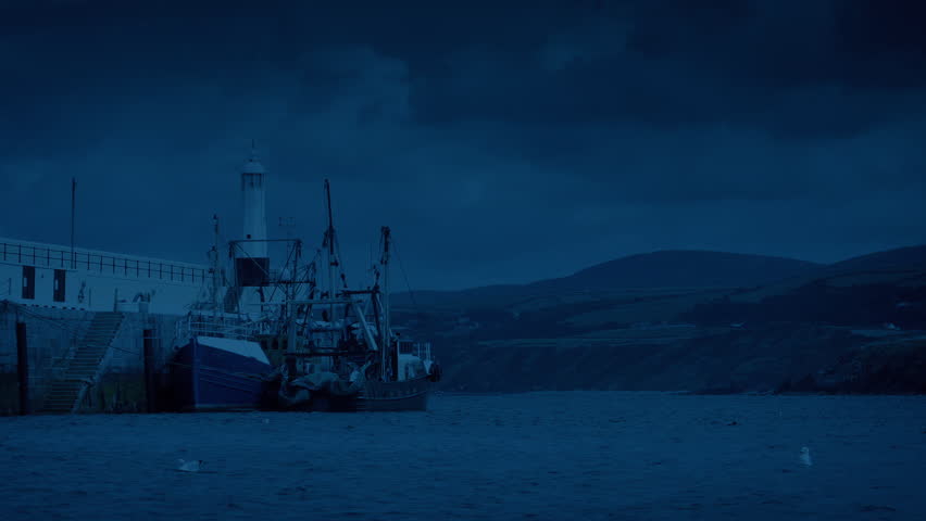 Fishing Boat By Harbor Wall In The Evening
