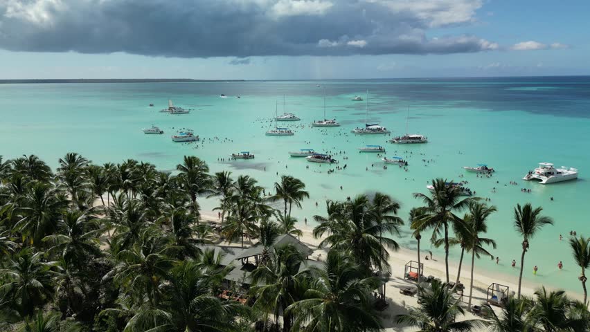 Drone clip of the famous Saona Island natural pool with excursion boats and vibrant Caribbean sea colors. Perfect for travel agencies and resort promotions