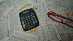 Activating overlay, data bars rising over calculator while glasses tilting and highlighting figures. Finance, analytics, data visualization, business technology, office work, digital interface - Powered by Shutterstock - Get 15% off with code: PIKWIZARD15