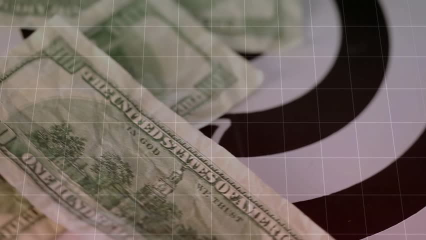 Folded dollar entering sparking bills drifting toward bullseye, chart rising showing strategy. Finance, investment, analysis, trading, currency, business, measurement