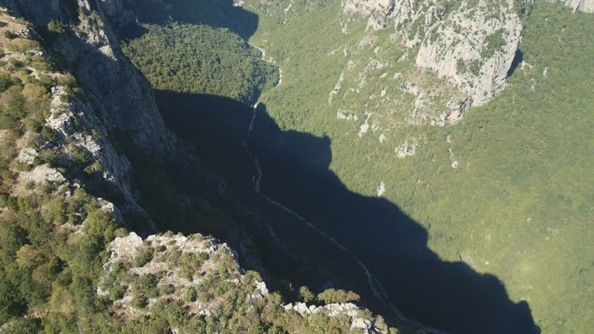 Drone footage of Vikos Gorge in Epirus, Greece, showing steep cliffs, lush greenery, and dramatic mountain landscape. Perfect for travel, nature, and documentary projects.
