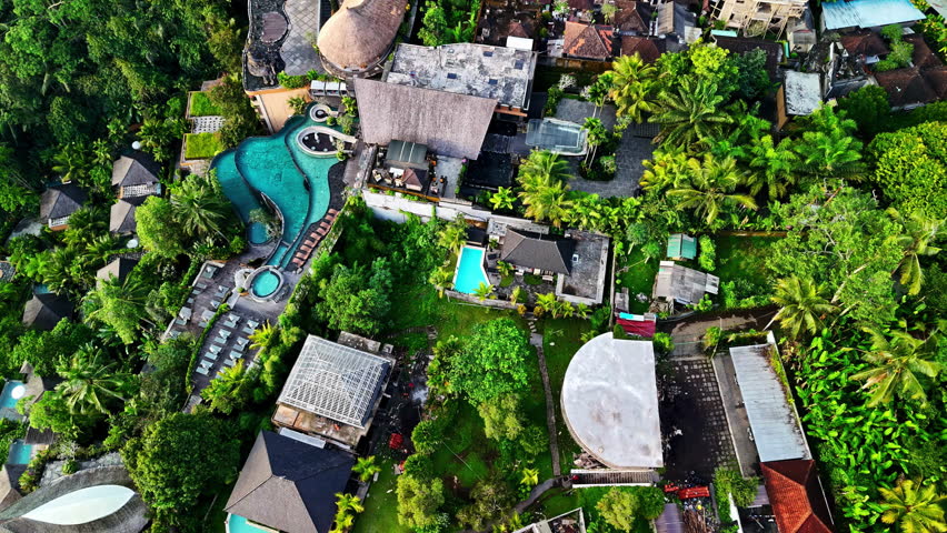Aerial shot of tropical resort in green environment.