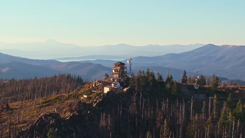 Scenic view of California fire lookout tower amidst mountains at sunset