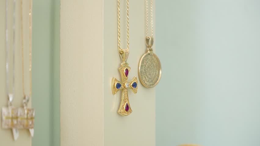 A stunning display showcases exquisite gold jewelry featuring intricate designs and colorful gemstones. The setting highlights the elegance and craftsmanship of each piece.