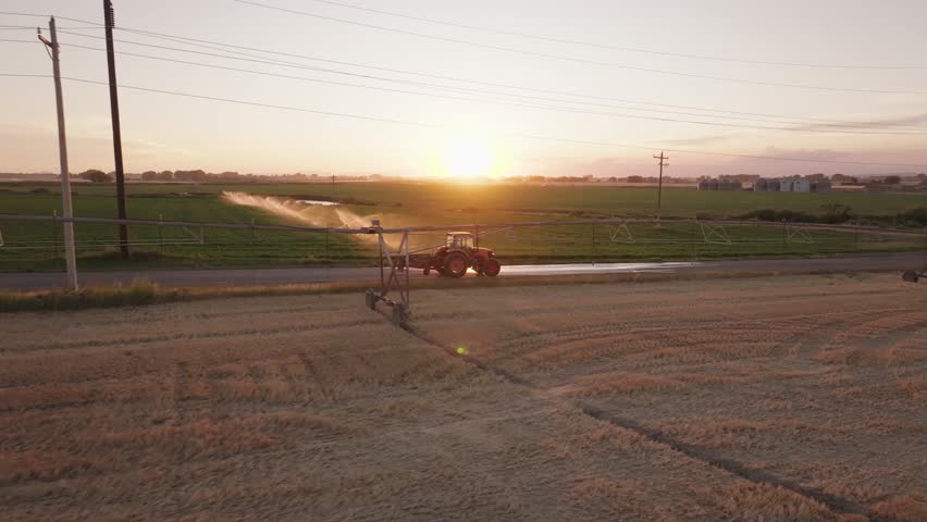 Drone shot of a tractor at sunset in Montana