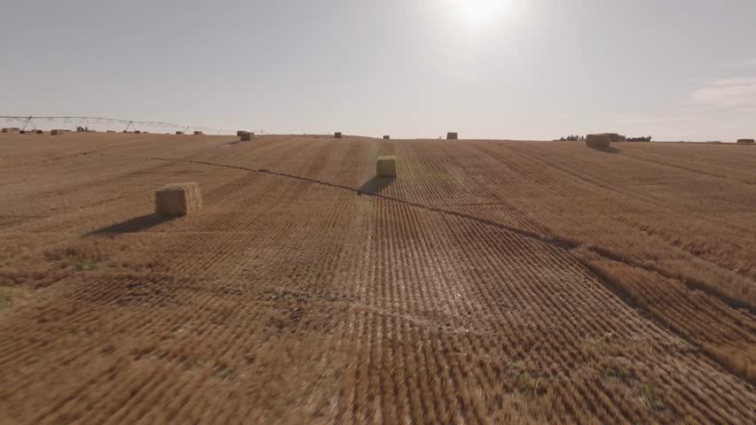 Drone shot of hay bales in Montana at sunset