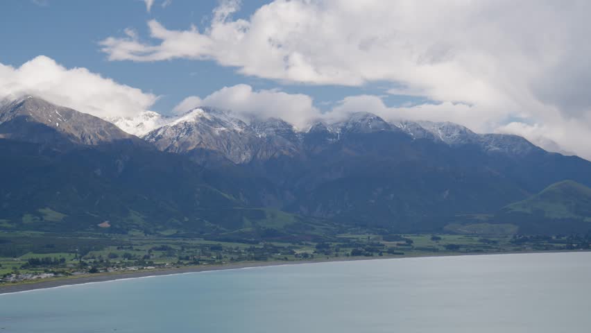 The Manakau mountains above Kaikoura, New Zealand with the ocean and a cloudy sky