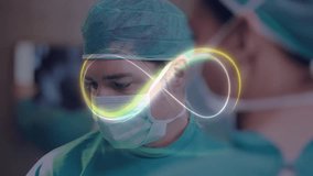 Male surgeon gazing down starting infinity-loop graphic moving over mask enhancing surgical focus. Medical, teamwork, innovation, precision, technology, healthcare, concentration - Powered by Shutterstock - Get 15% off with code: PIKWIZARD15