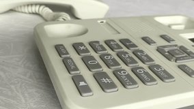 A woman dials a phone number on a landline phone. Your finger presses on the numbers on the phone dial in the call center. Telecom operator - Powered by Shutterstock - Get 15% off with code: PIKWIZARD15