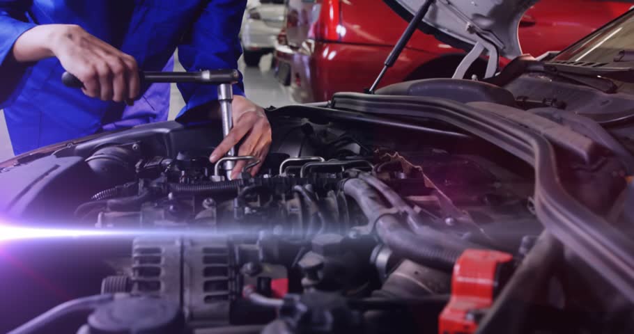 Female auto mechanic gripping wrench and loosening manifold bolt, inspecting part for engine power. Automotive, repair, mechanic, workshop, tools, vehicle, industrial