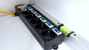 Finger presses individual switches on a multi-outlet power strip-each click powers a device, showing precise control and clear LED feedback in a clean setup - Powered by Shutterstock - Get 15% off with code: PIKWIZARD15