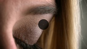 Woman lifting right eyelid activating AR map with scrolling code, icons linking global data. Futuristic, technology, connectivity, innovation, digital, holographic, network - Powered by Shutterstock - Get 15% off with code: PIKWIZARD15