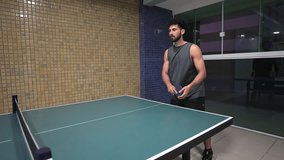 Latin young adult practicing ping pong, table tennis indoors, for health and active lifestyle - Powered by Shutterstock - Get 15% off with code: PIKWIZARD15