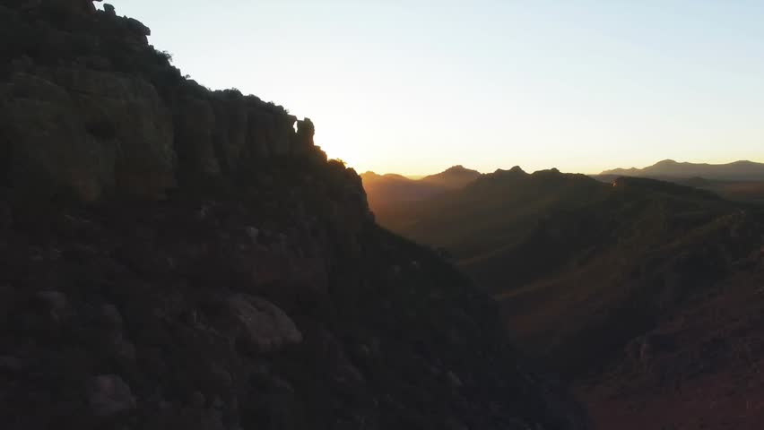 Sun peeking over peaks initiating gold diamond overlay rotating flooding valley to highlight warmth. Mountain, sunrise, geometric, abstract, landscape, dawn, warmth - Powered by Shutterstock - Get 15% off with code: PIKWIZARD15