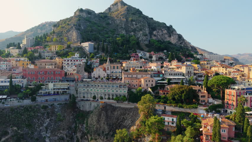 Scenic view of Taormina, Sicily, with mountains and historic buildings