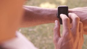 Man raising arm tapping smartwatch in backyard creating subscribe and like social media overlays. Technology, wristwear, digital, modern, outdoor, lifestyle, innovation - Powered by Shutterstock - Get 15% off with code: PIKWIZARD15