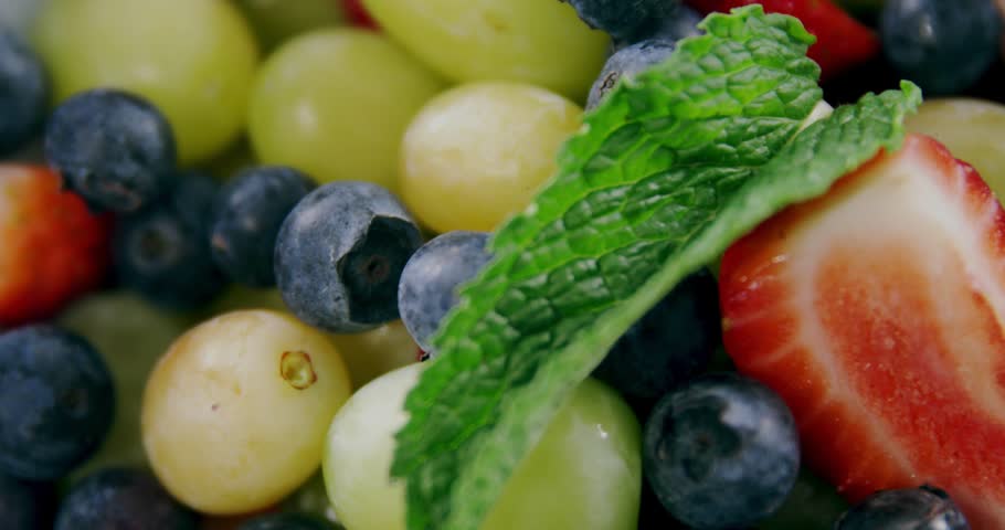 Fruit bowl reveal activating HUD panels fading over berries, updating numeric codes pulsing charts. Freshness, vibrancy, digital, data, technology, nutrition, health