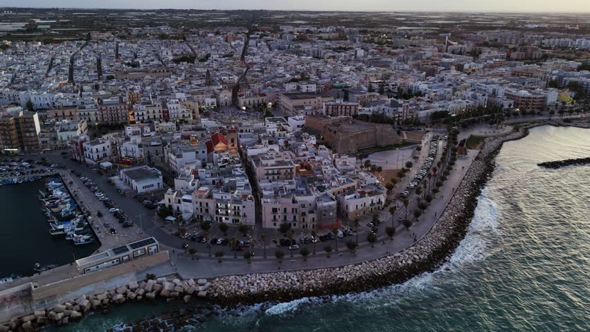 Coastal cityscape of Mola di Bari, aerial orbit view