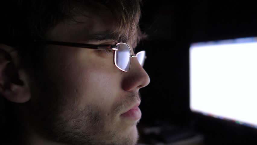 Focused male trader analyzing cryptocurrency market trends on computer screen, showcasing intense concentration and engagement in digital trading environment, capturing the essence of modern finance