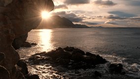 Sunrise with warm sunburst and scenic clouds over Walker Bay ocean, Hermanus - Powered by Shutterstock - Get 15% off with code: PIKWIZARD15