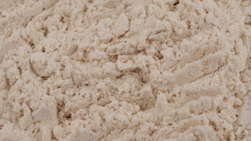 Take out a measuring spoon filled with white protein powder. Close-up of sports nutrition supplement for fitness, healthy diet, muscle recovery concept. Vanilla whey powder. Bodybuilding gym lifestyle