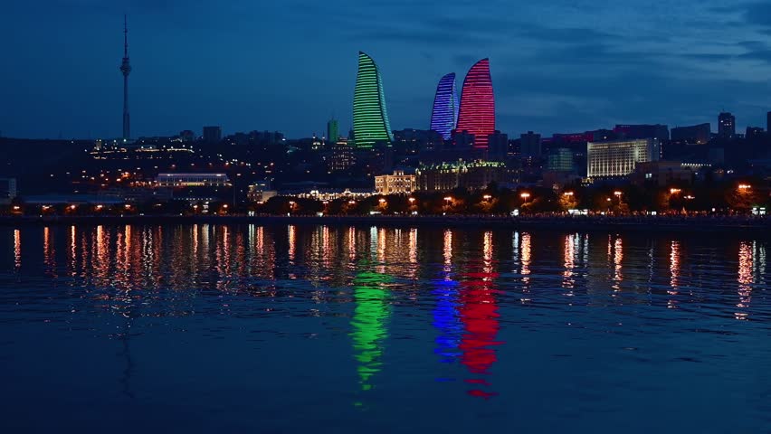 Cityscape of Baku, Azerbaijan taken at night with the Caspian Sea in the foreground