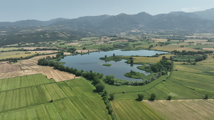 Italian Rural Landscape With Clear Blue Lake and Mountains