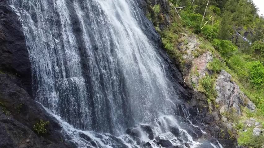 Close aerial footage of a drone showing the waterfall of voile de la mariee in La Reunion island.