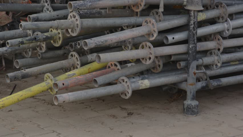Tilt up of a lot of scaffold standards stacked up on an industrial worksite