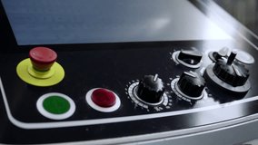 Close-up of the control panel on an industrial CNC machine with various buttons, dials, and a red emergency stop, conveying automation and technical operation - Powered by Shutterstock - Get 15% off with code: PIKWIZARD15