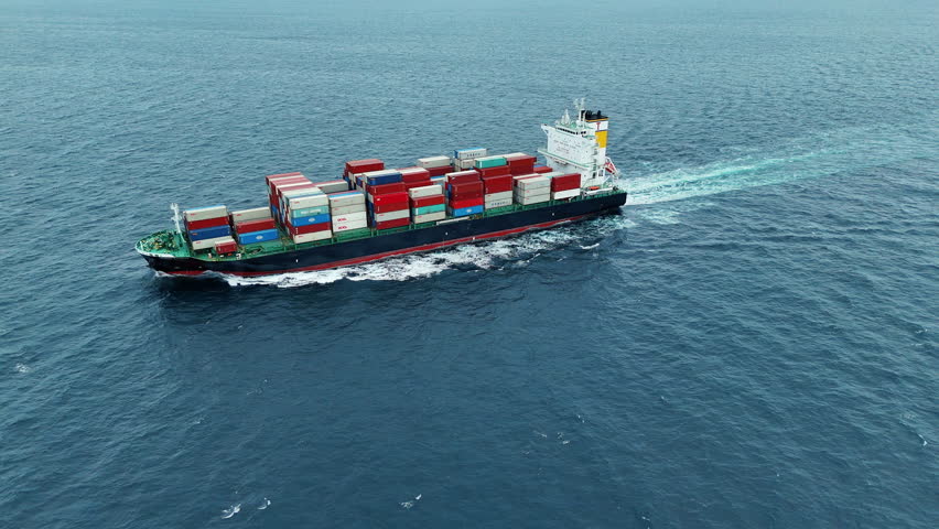Aerial of cargo ship carrying container and running verry fast for export cargo from cargo yard port to other ocean concept smart freight shipping ship top view