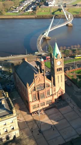 Overhead social ratio aerial of the Peace Bridge and Guildhall in Derry, AKA Londonderry in Northern Ireland. Filmed in 1080x1920, 60FPS and with Rec709 color.