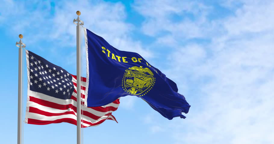 Oregon state flag waving with the american flag on a clear day. The Oregon flag is two-sided with navy blue and gold colors. Seamless 3d render animation. Slow motion loop. Selective focus