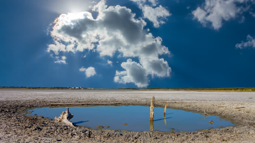 small puddle among saline land under the hot summer sun time lapse scene