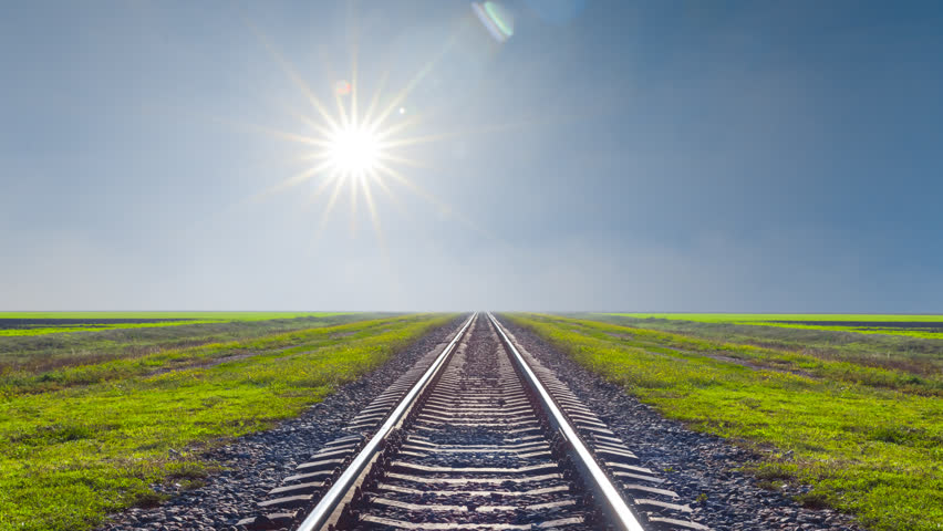 railway among green plain under a sparkle sun time lapse scene