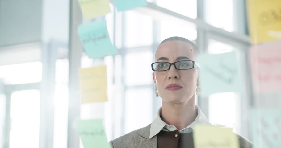 Business woman, sticky notes and writing on glass wall for strategy, mind map and planning. SEO manager, employee and arrow to info in office for competitor analysis, market research or brainstorming