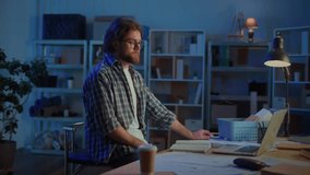 Man Talking Online at Desk Late at Night, Using Laptop in Home Office or Garage. Concept of Remote Work, Online Communication, Learning, Video Calls, and Staying Connected from Home at Night. - Powered by Shutterstock - Get 15% off with code: PIKWIZARD15