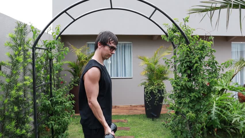 Man does weight training with dumbbells