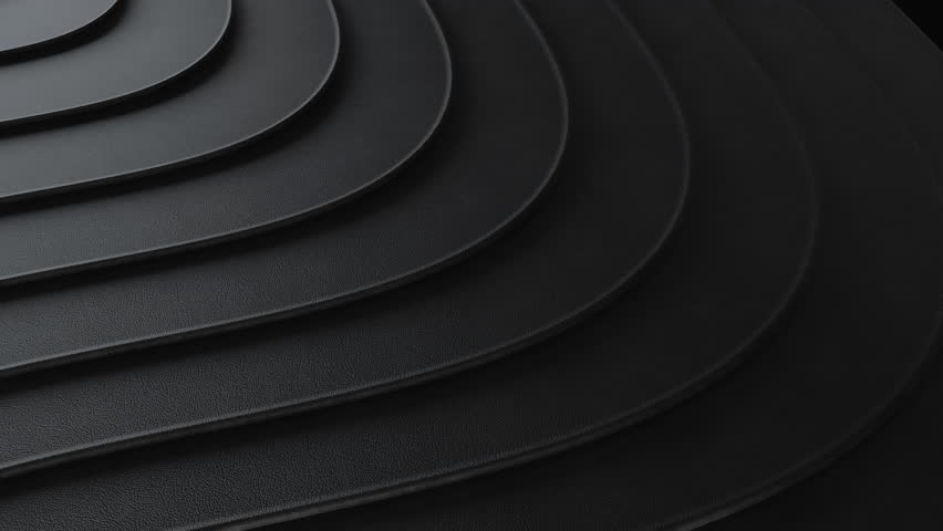 A striking abstract background featuring dark, textured, overlapping curved layers creating a modern, minimalist pattern. The subtle shadows and repeating arcs convey depth and sophistication