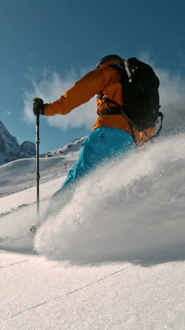 Skier riding in the scenic Dolomites mountains in fresh powder snow. Super slow motion at 1000 fps.