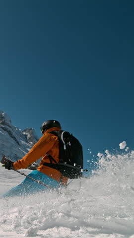 Skier riding in the scenic Dolomites mountains in fresh powder snow. Super slow motion at 1000 fps.