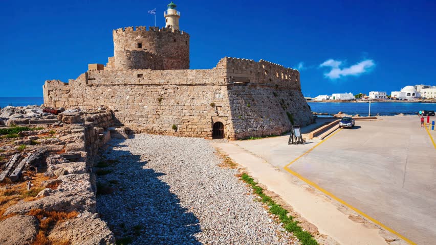Saint Nicholas Fort guards the Mandraki harbour in Rhodes city, capital of Rhodes island in Greece Saint Nicholas Fort at the Mandraki harbour in Rhodes city, capital of Rhodes island in Greece