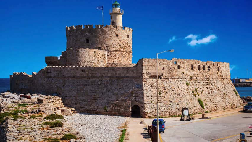 Saint Nicholas Fort guards the Mandraki harbour in Rhodes city, capital of Rhodes island in Greece Saint Nicholas Fort guards the Mandraki harbour in Rhodes city, capital of Rhodes island in Greece