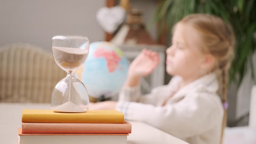 schoolgirl studies at home, girl Student learning geography with globe map, hourglass measuring time, global knowledge, back to school, Child homework, time management, Education and childhood - Powered by Shutterstock - Get 15% off with code: PIKWIZARD15