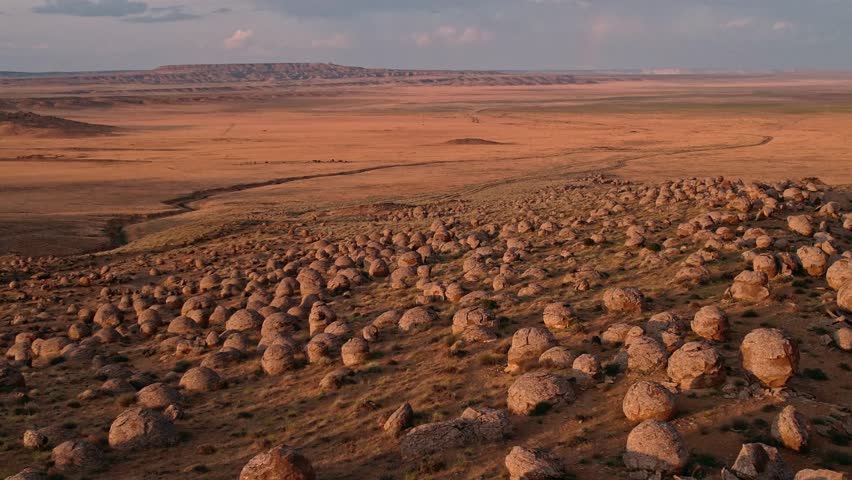 Experience the Stunning View of Unique Rock Formations amidst the Expansive Desert Landscape