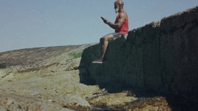 Man lifting smartphone and scrolling to review data by rocky shore, tech data overlays drifting. Outdoors, technology, fitness, rugged, digital, leisure, communication - Powered by Shutterstock - Get 15% off with code: PIKWIZARD15