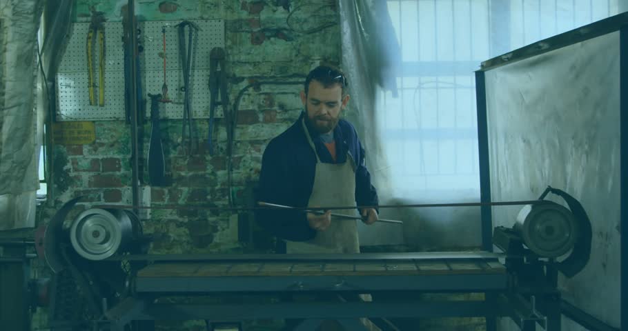 Craftsman mounting metal rod on lathe, guiding cutting tool shaping cylinder in metal shop daylight. Industrial, workshop, machining, craftsmanship, manual, engineering, precision